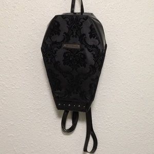 Black, coffin shaped backpack.